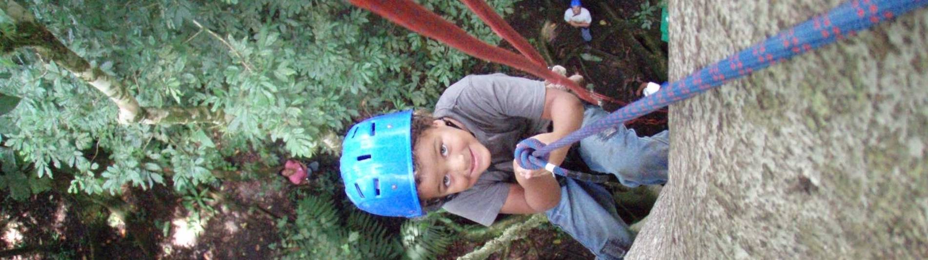 Serendipity Costa Rica guest exiting tree trunk to rappel back to jungle floor